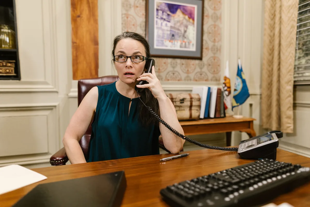 Responsable de un negocio hablando por teléfono en su despacho